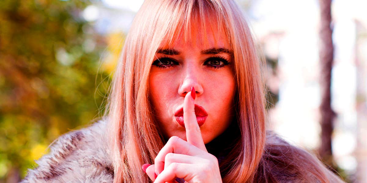 Excuses People Give For Cheating That Are Total Lies secretive woman hushing