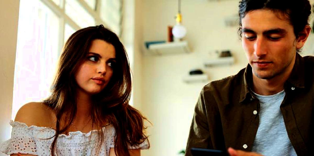 What It Means When A Guy Says He Likes You But Doesn't Make An Effort woman looking disappointed with guy who isn't making an effort