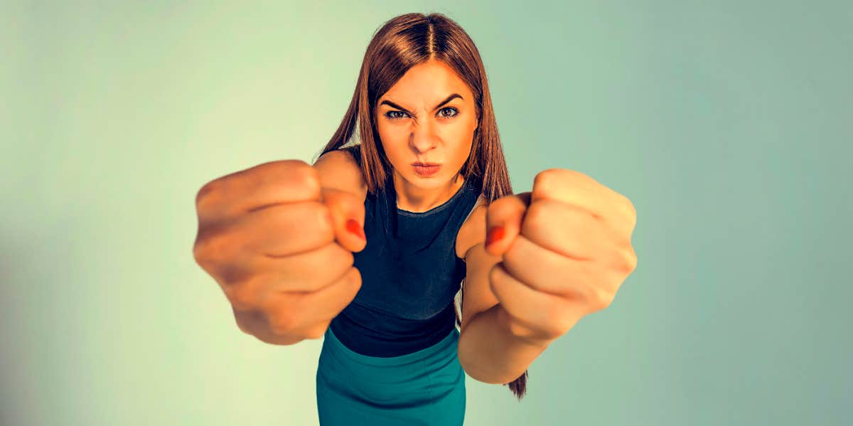 angry wife holding up her hands in fists