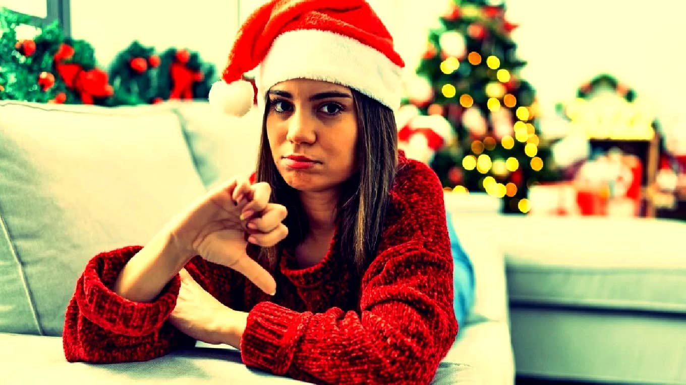 woman in Santa hat giving thumbs down