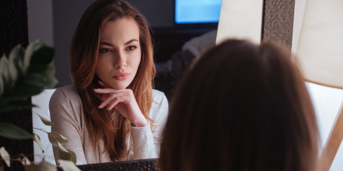 woman looking in the mirror