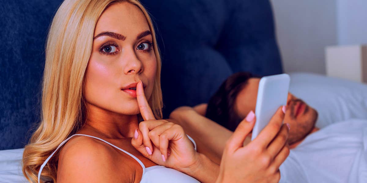woman secretly on phone cheating