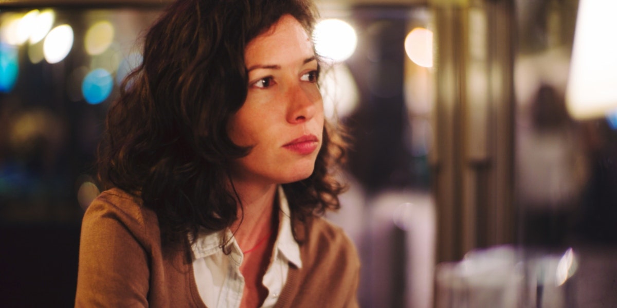 woman with short brown hair looking into the distance