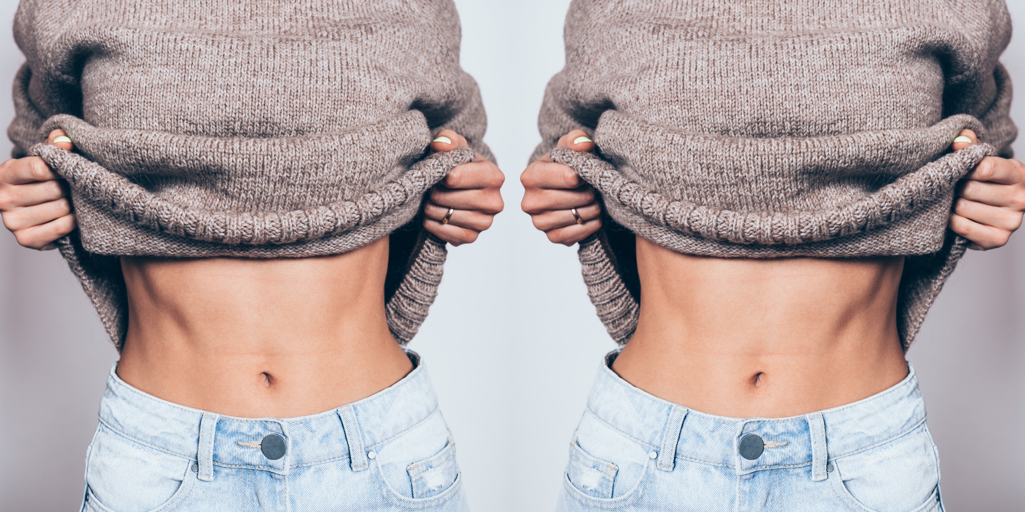 woman holding up sweater showing belly button