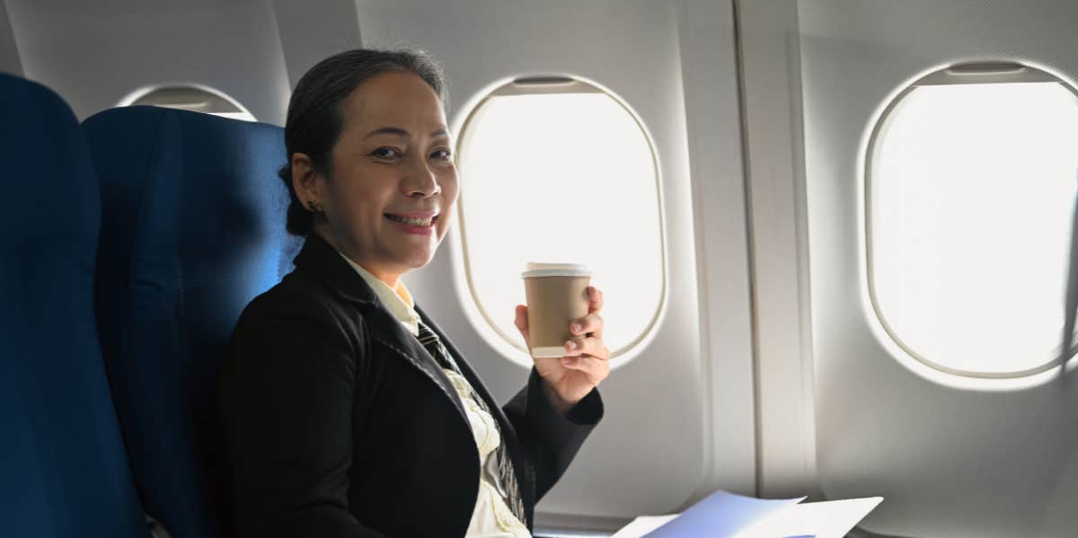The Disgusting Reason Flight Attendants Say No One Should Drink Coffee On Airplanes woman on airplane