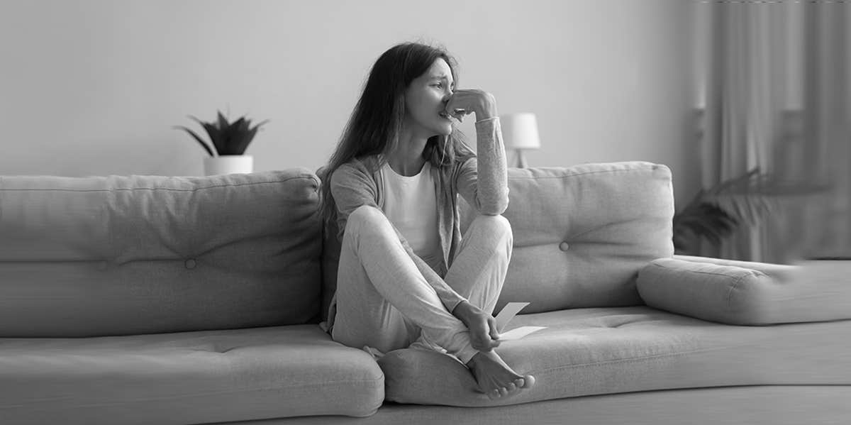Why 50% Of Women Regret Marrying Their Husbands lady looking sad sitting in a couch