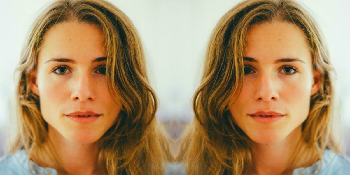 Why Geminis Are So Detached woman with long, wavy dark blonde hair looks into the camera in soft focus