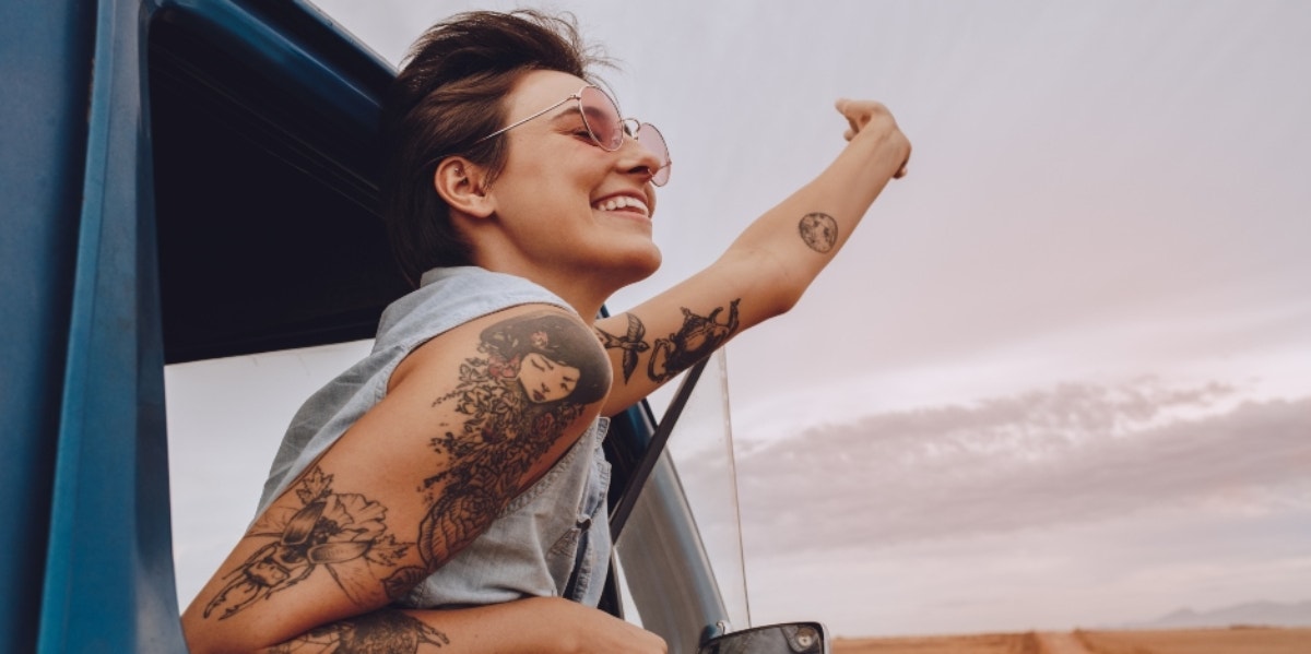 woman in car smiling out the window