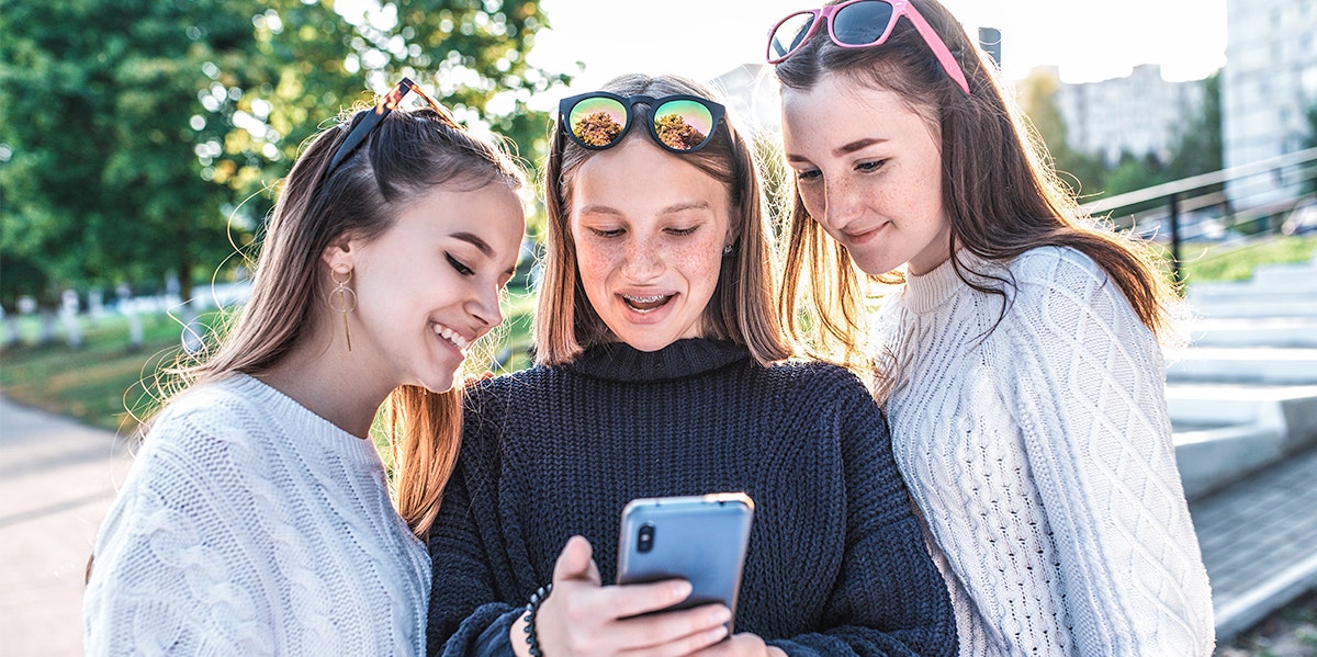 group of girlfriends looking at phone