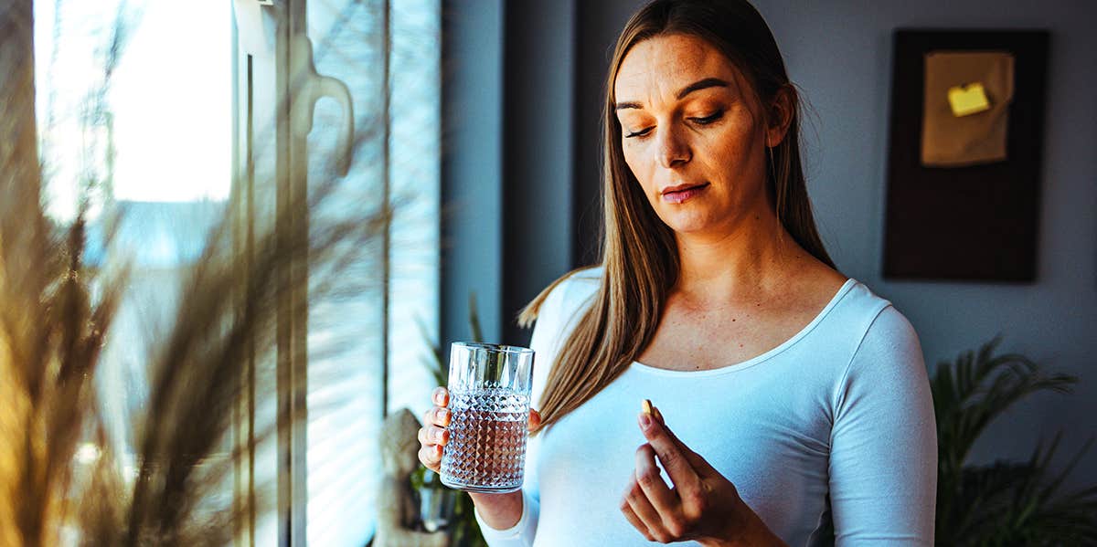 woman taking pill