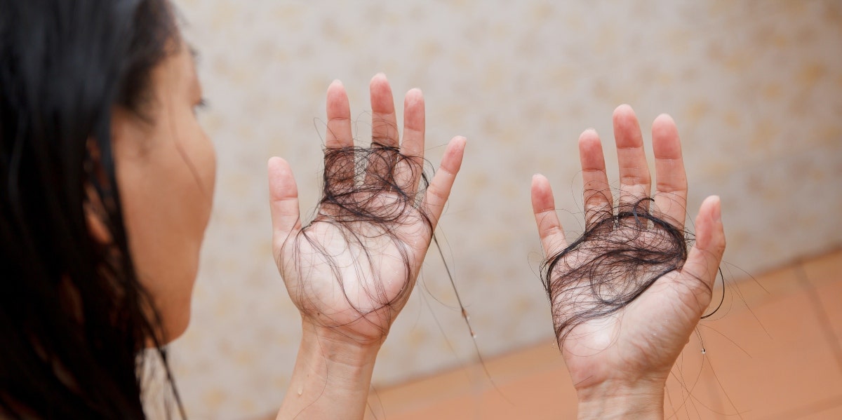 woman holding hair in her hands