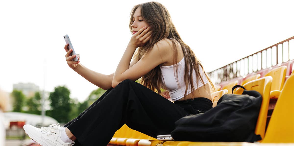 Why It Doesn't Matter That I Didn't Have Friends In High School high school girl sitting on bleachers
