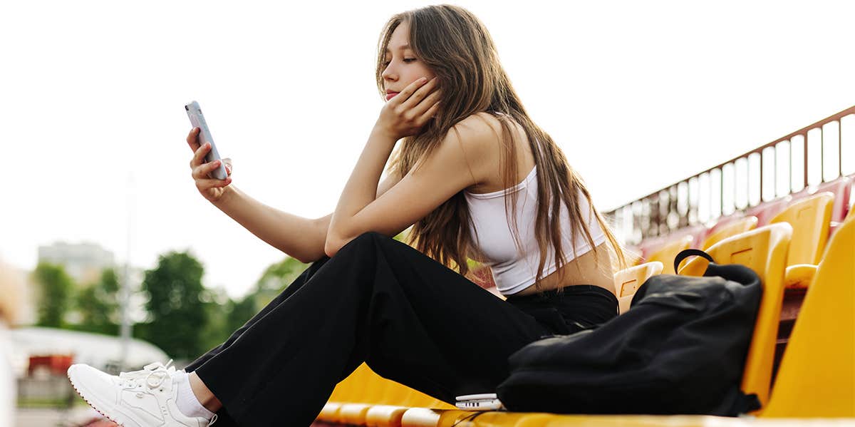 high school girl sitting on bleachers