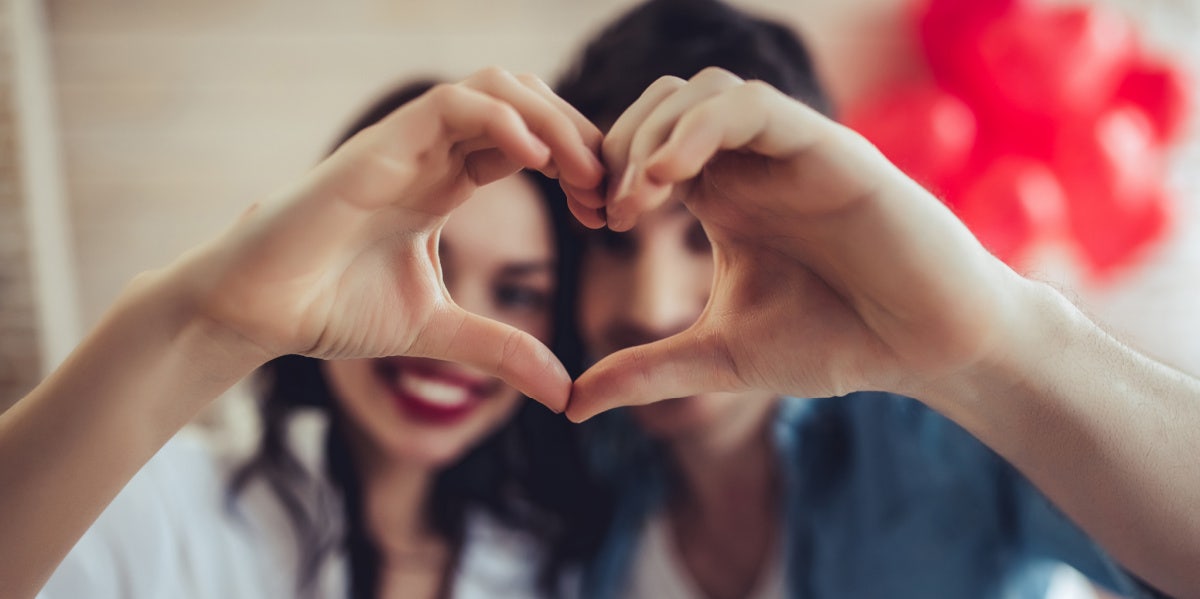 couple holding up left and right hands