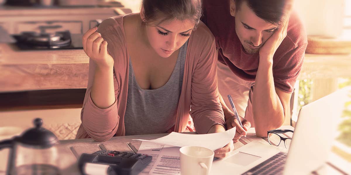 Why Lying About Money Is Way Worse Than An Affair couple looking at the bill
