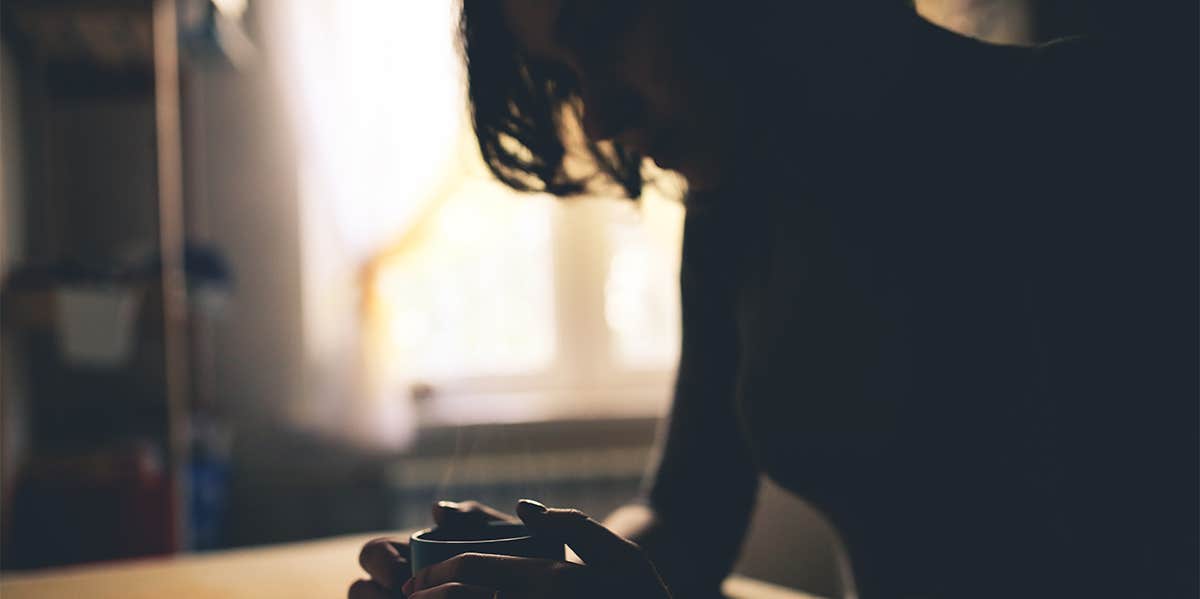 Why The Memories You Choose To Forget Are Actually Worth Remembering woman sitting in the dark with cup of coffee