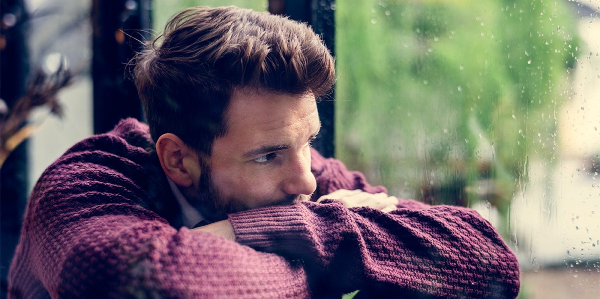 man looking out a window giving silent treatment