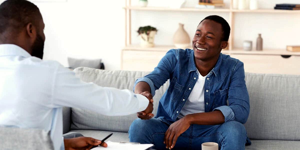 Why All Men Need Therapy, According To A Male Therapist man smiling as he shakes hands with his therapist