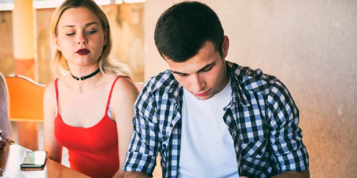 woman sitting next to man who is pulling away