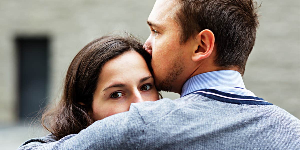 sad couple, woman looking at camera, man looking at her