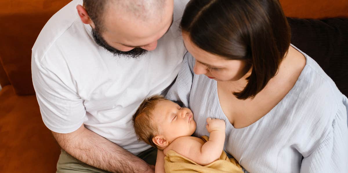 new parents holding baby