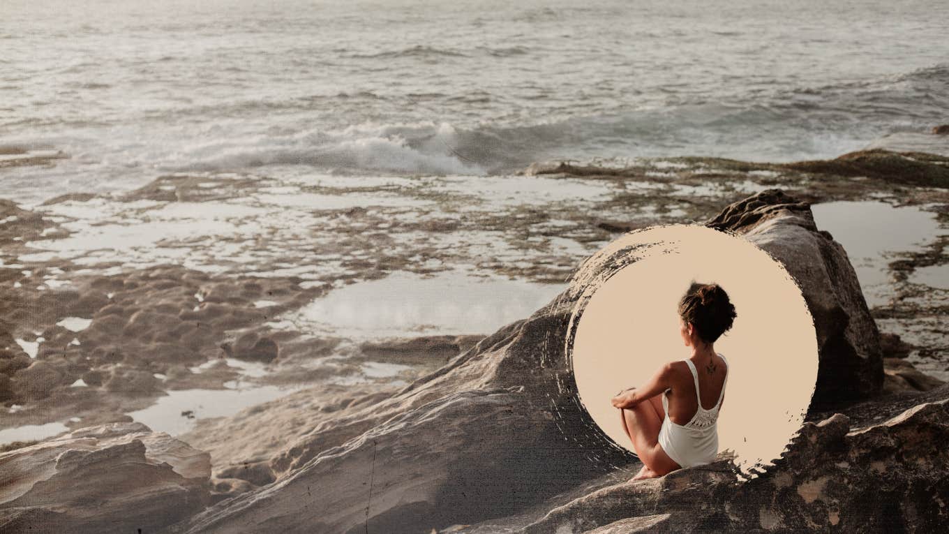 Woman sitting on rocks taking time for herself