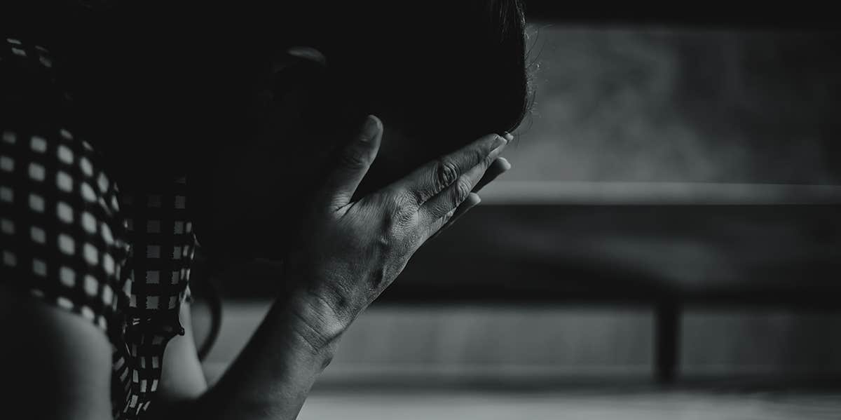 Why It Took Me 25 Years To Admit I Was Raped sad woman crying with hands covering face