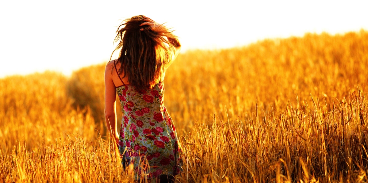 woman walking in field 