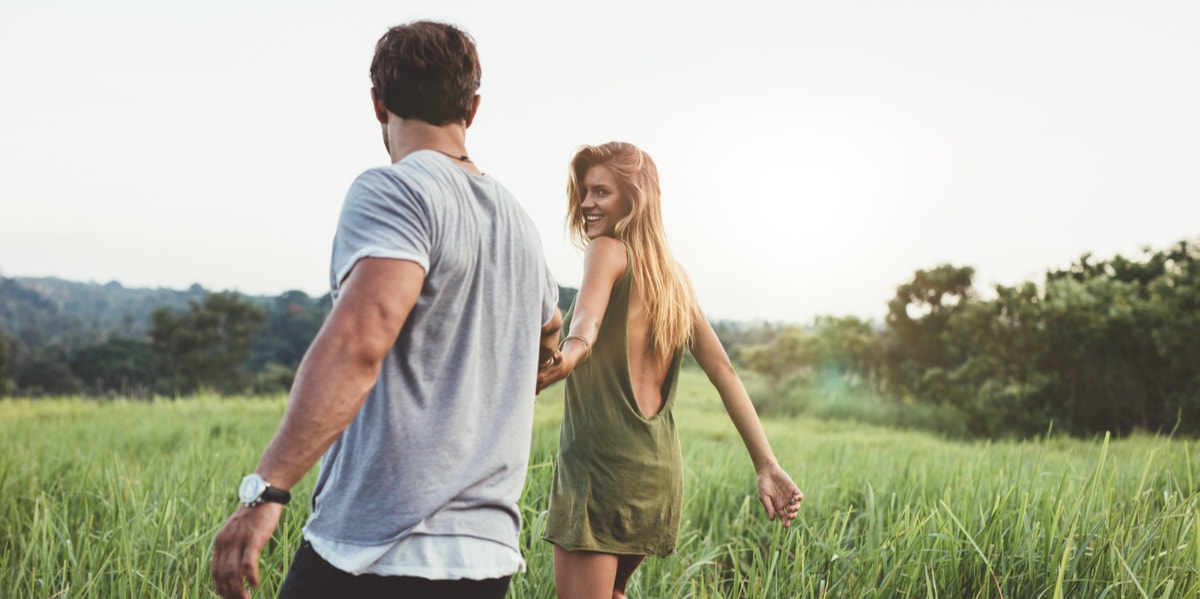 couple holding hands walking