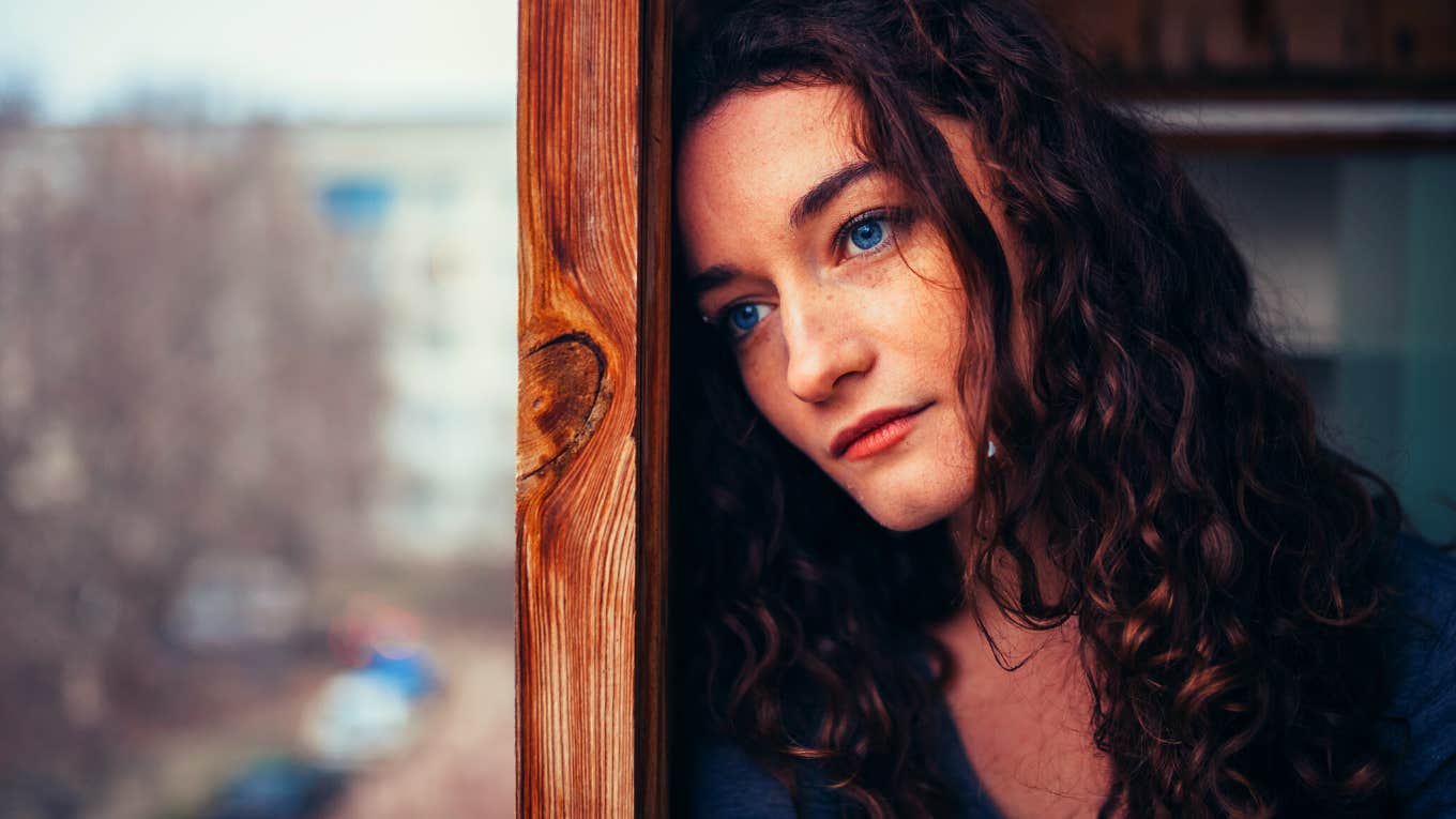 beautiful sad lonely girl sitting near the window is missing