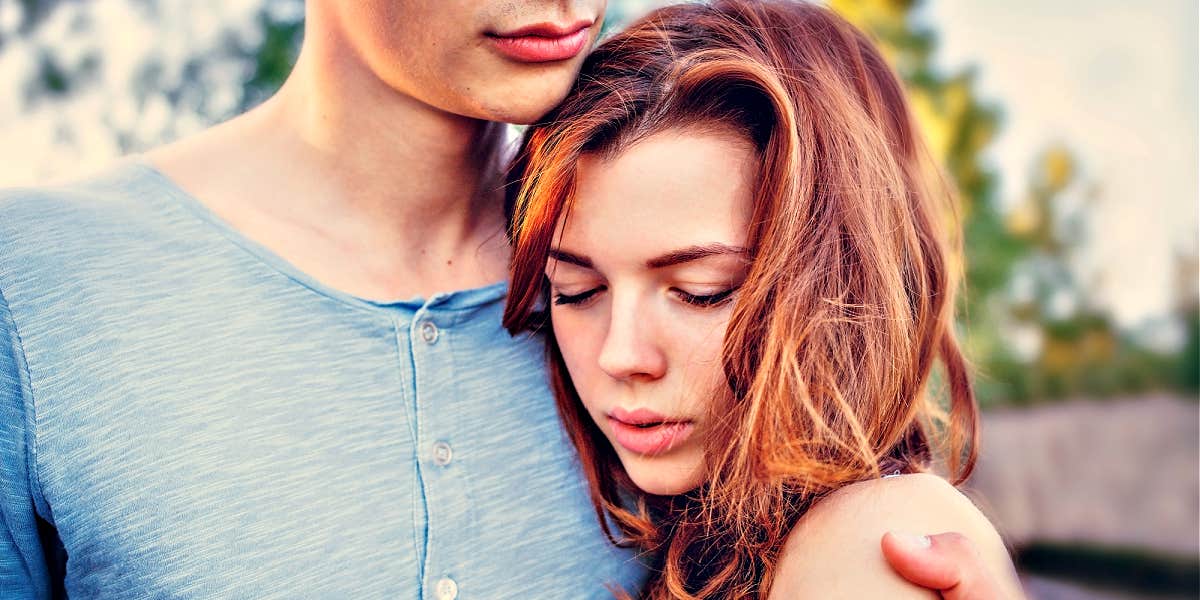 why women like emotionally unhealthy men woman sadly nestled into man's chest