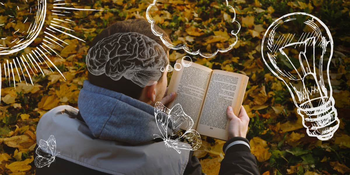 Man reading book outside