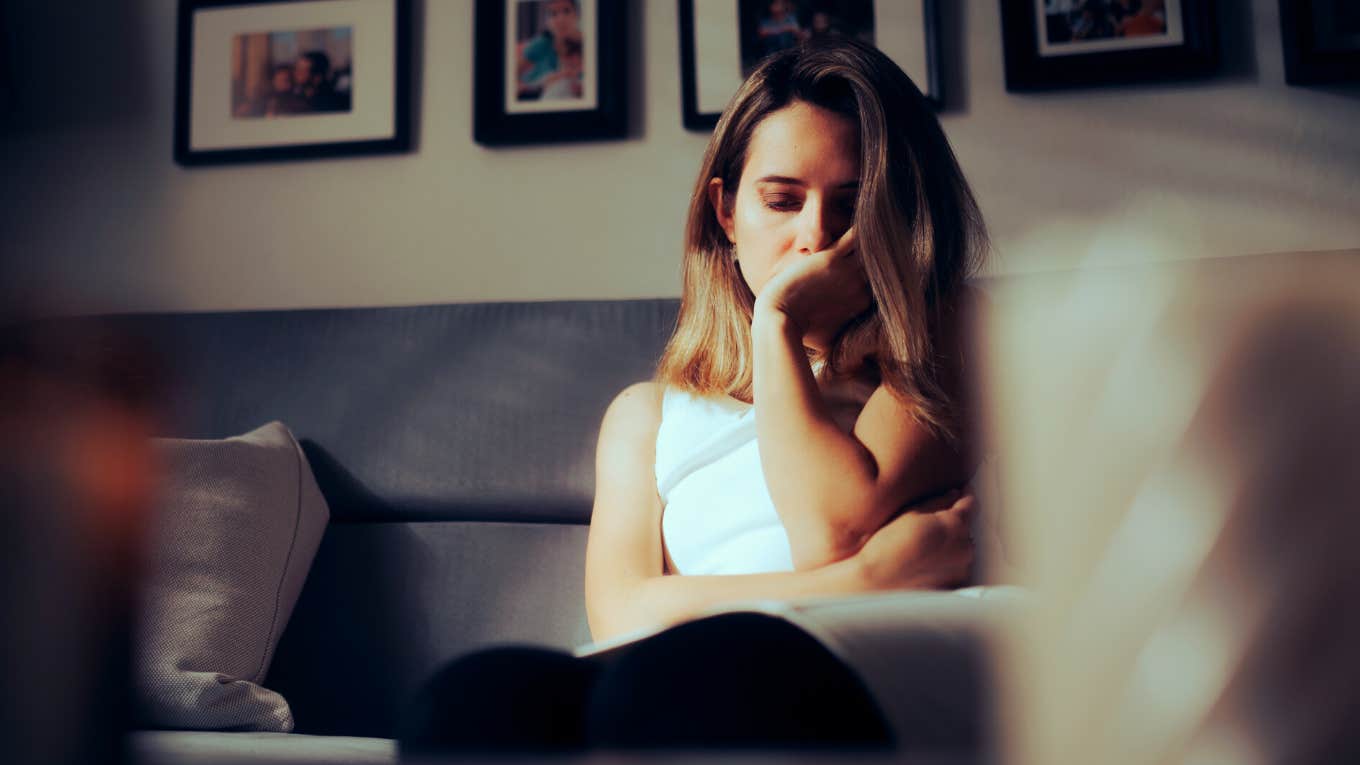 sad woman sitting alone on the couch