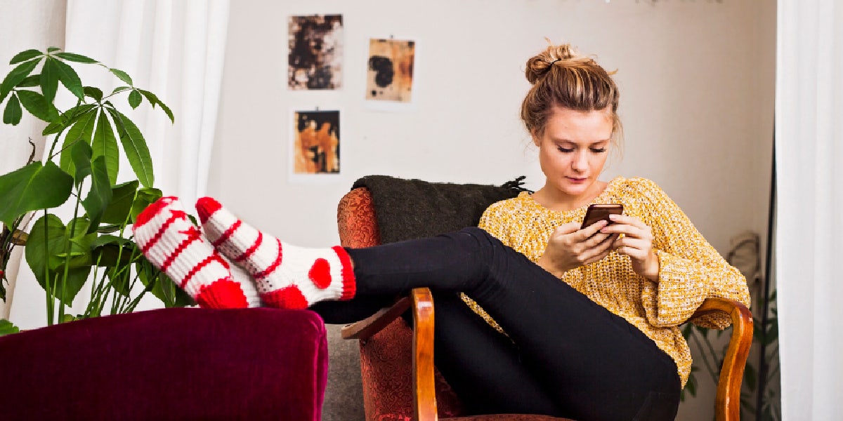 What It Means If He Unblocks You, By Zodiac Sign woman on her phone
