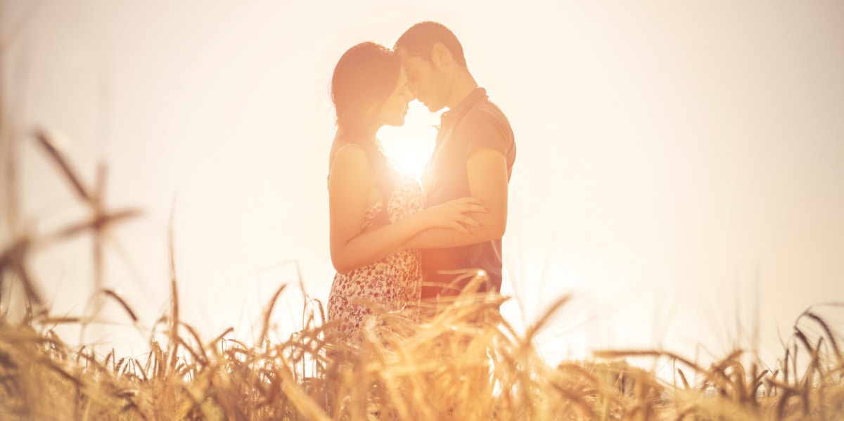 couple hugging in field