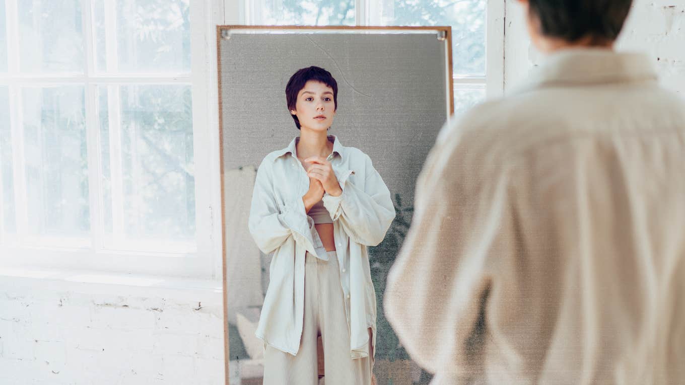 Woman looking at herself in mirror