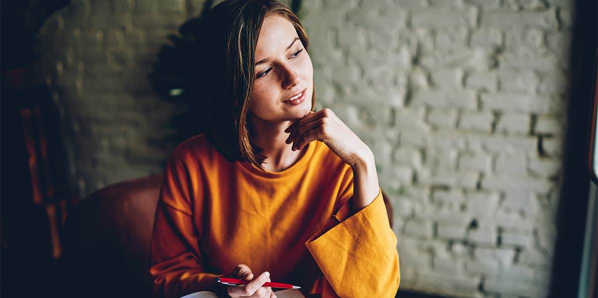 thoughtful woman writing