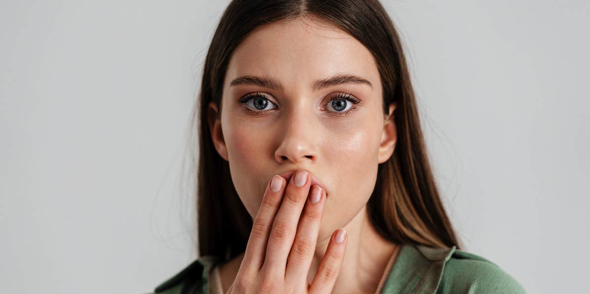 woman covering mouth