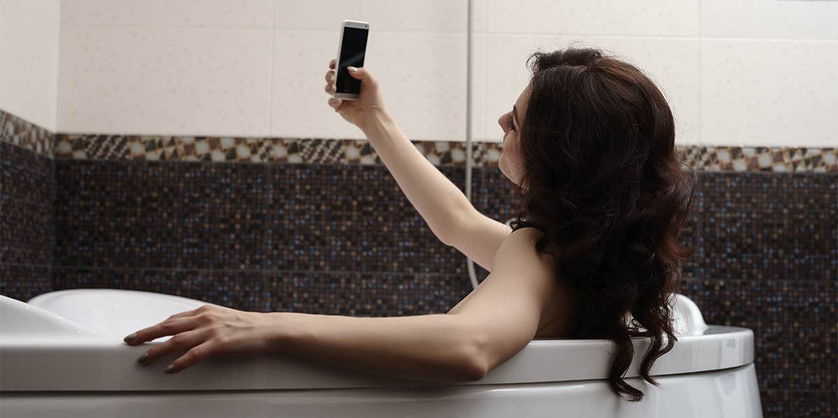 Why You Should Feel Empowered Taking Nudes woman taking selfie in bath