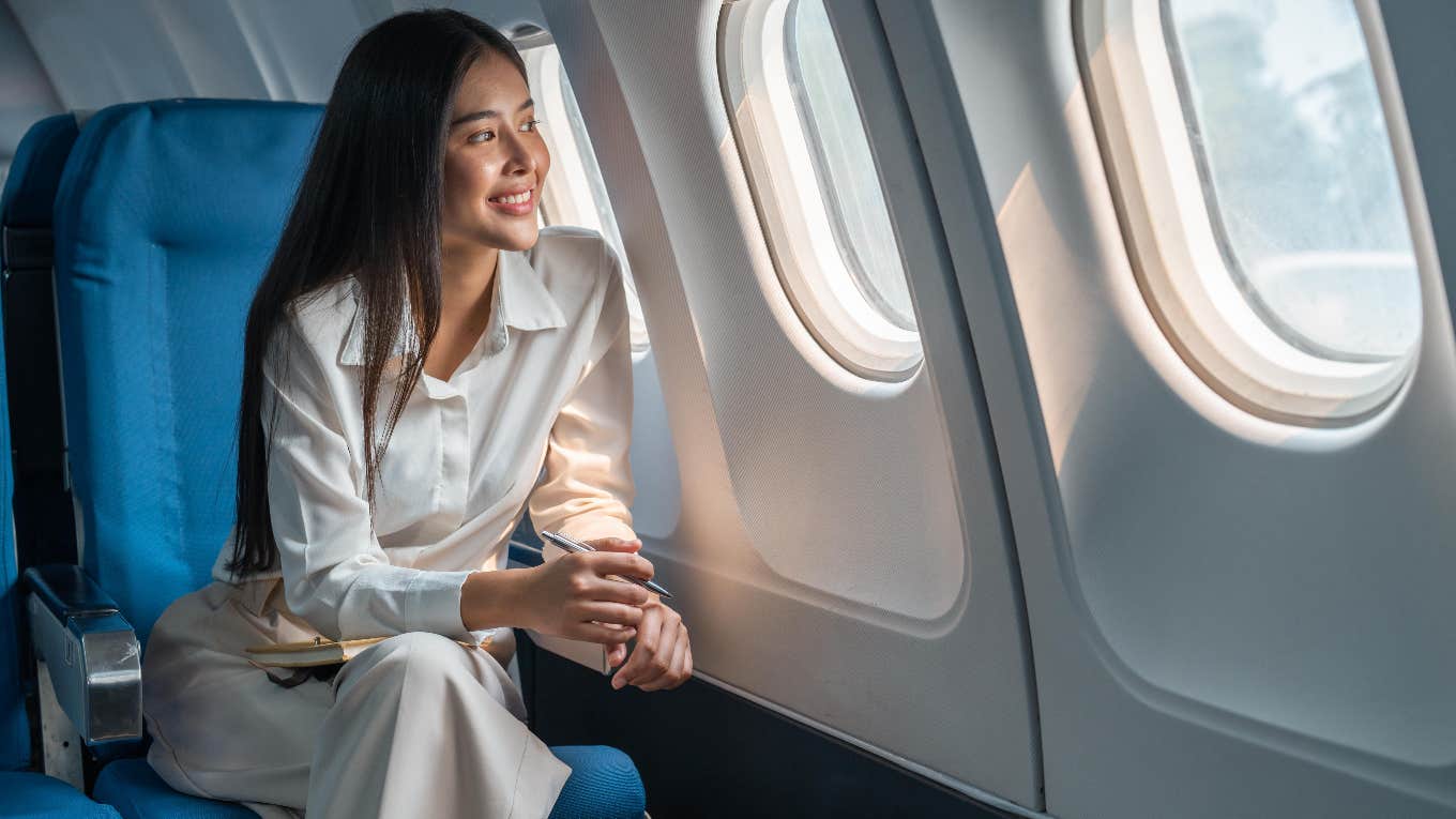 Why You Shouldn't Buy 3 Seats In A Row To Give Yourself More Space When Flying woman on a plane