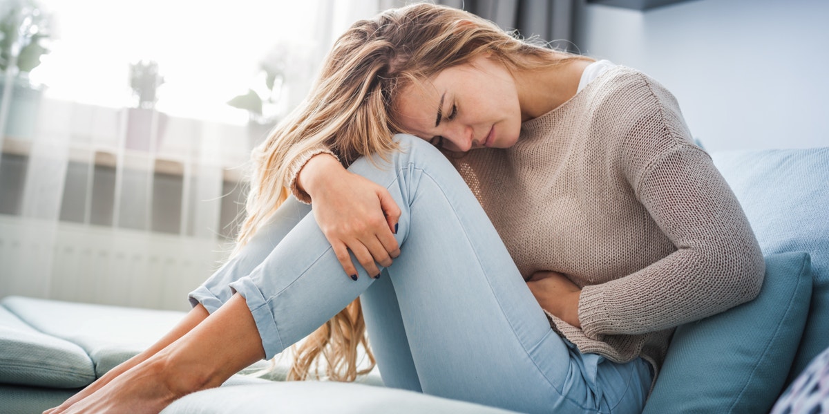 I Refuse To Hide My Period From My Kids — And Neither Should You woman having period cramps
