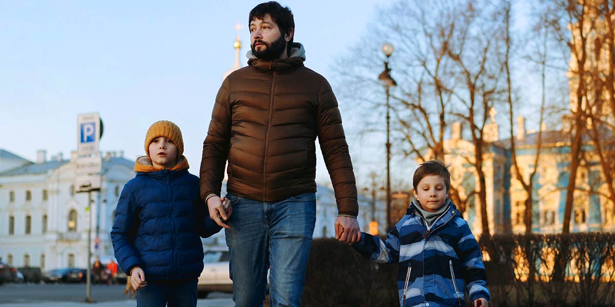 dad walking with his two sons