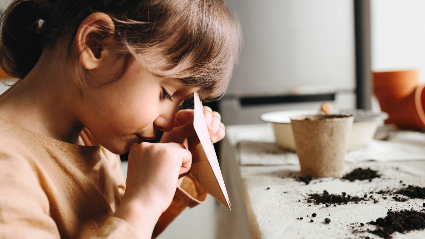 little girl planting flowers