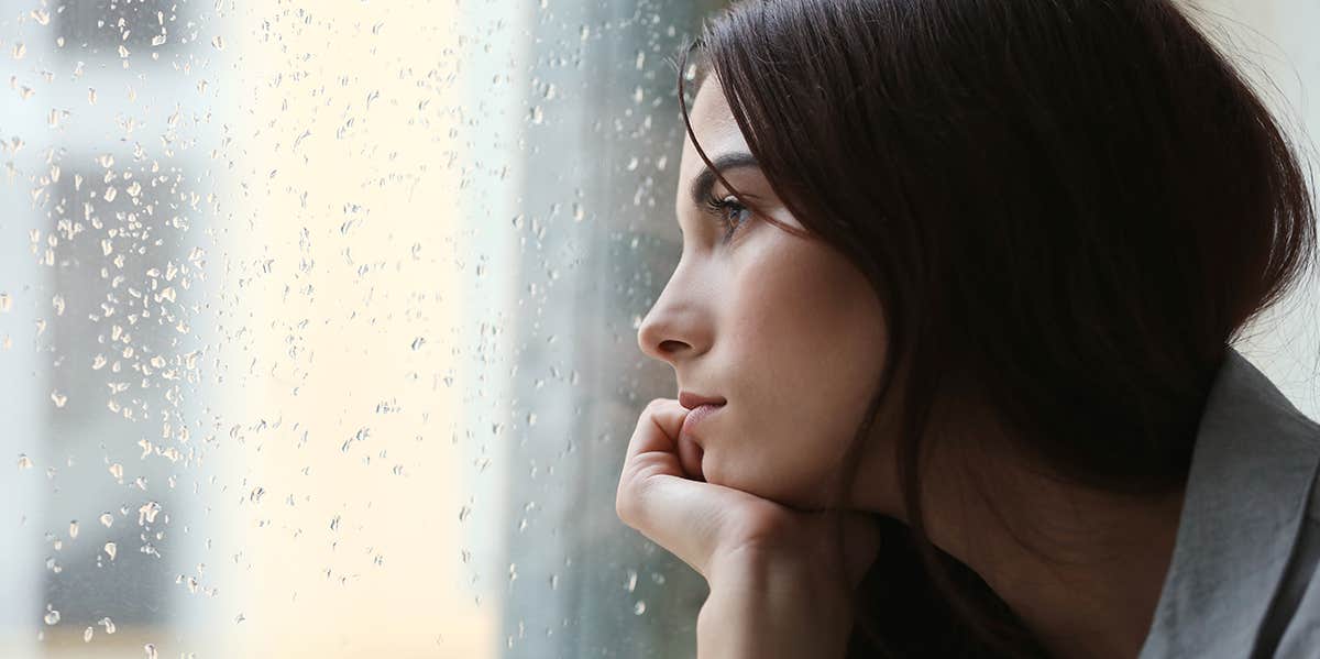 Why Your Ex Dumped You — Even Though They Say They Still Love You woman looking longingly out window