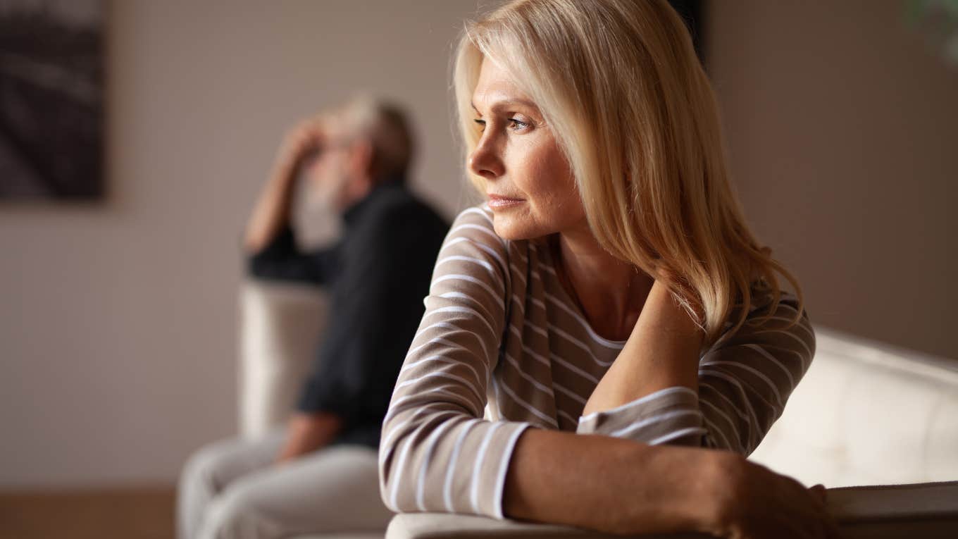 upset couple sitting on opposite ends of couch