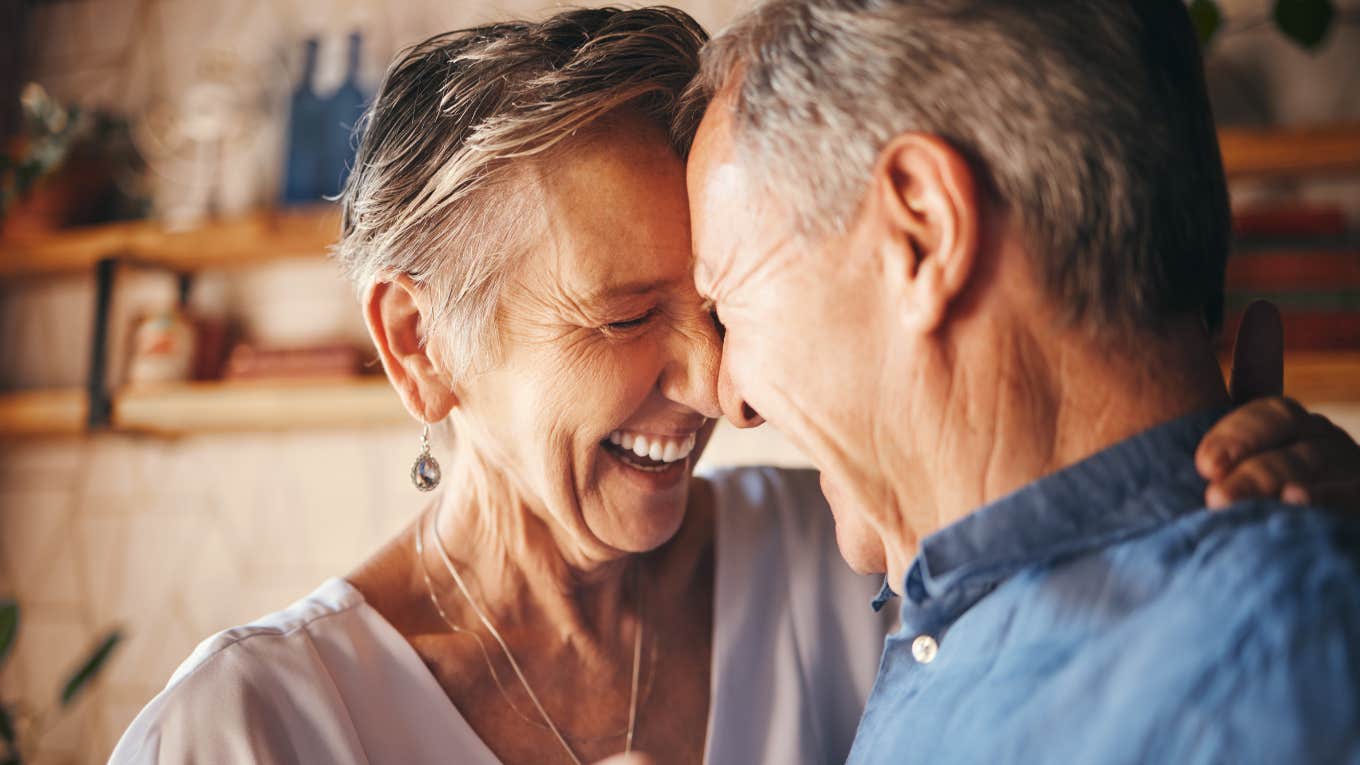 close up portrait of elderly couple laughing and dancing together