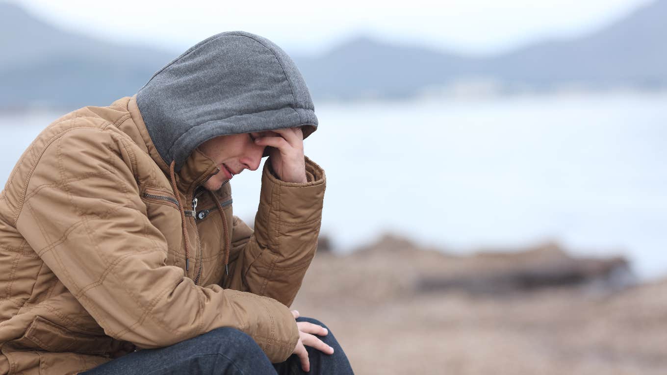 man siting outside in cold