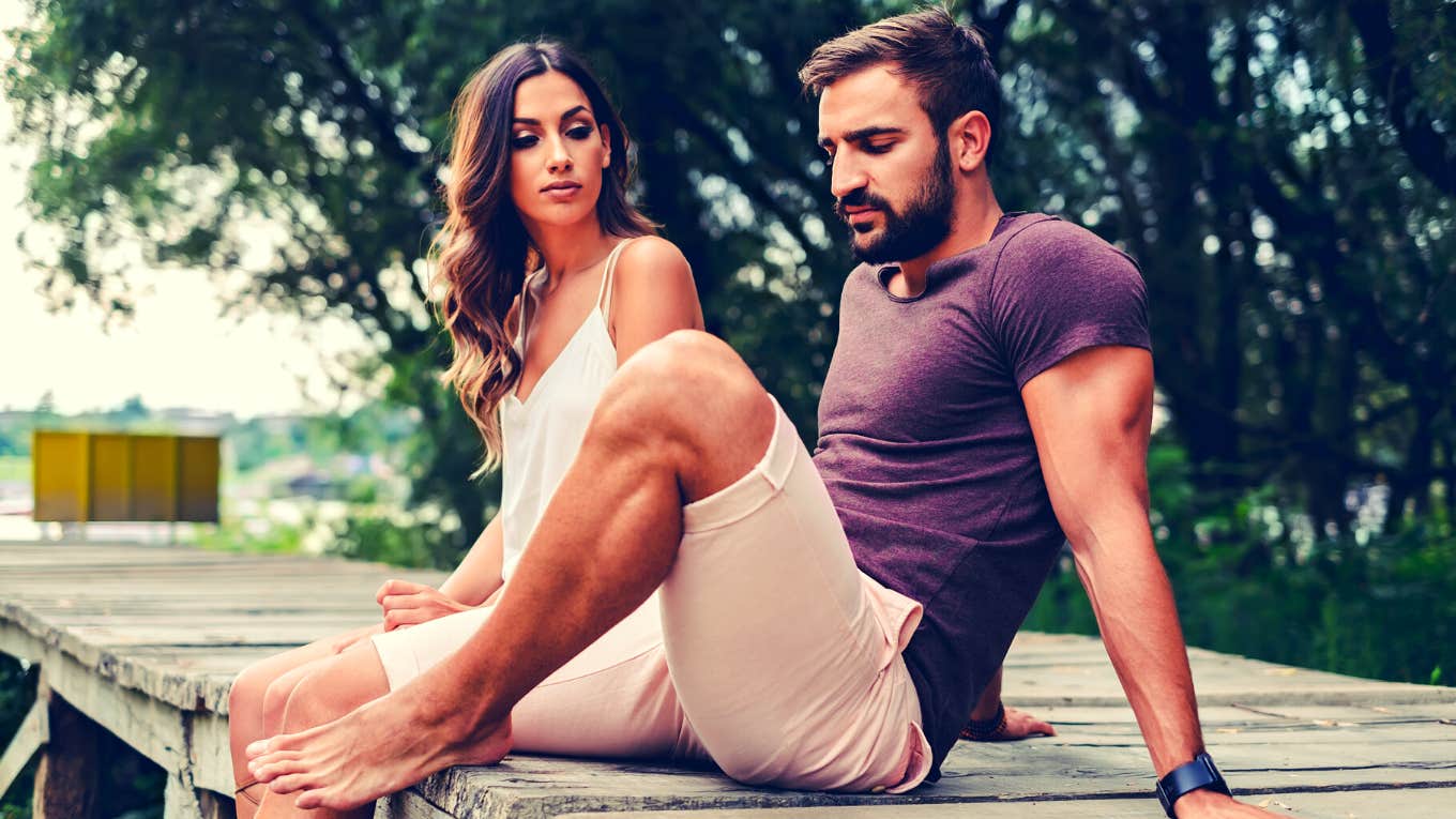 Couple fighting while sitting on the pier