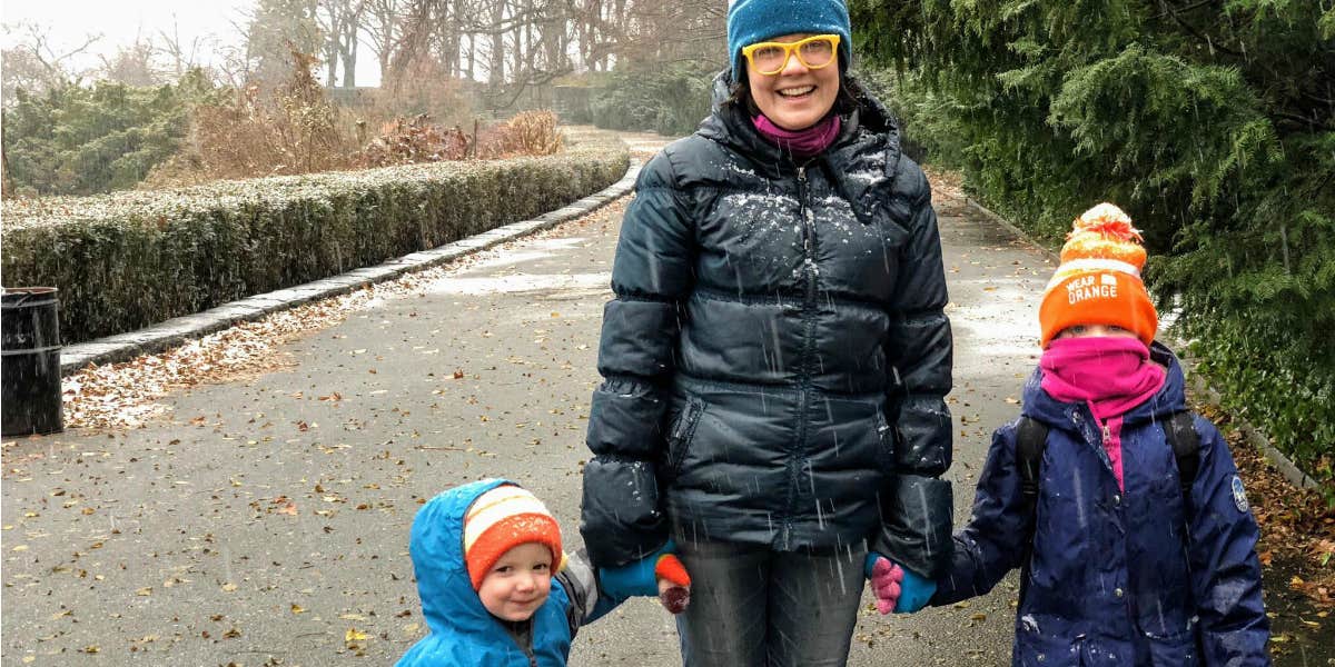 mom walking with her two young children on winter solstice