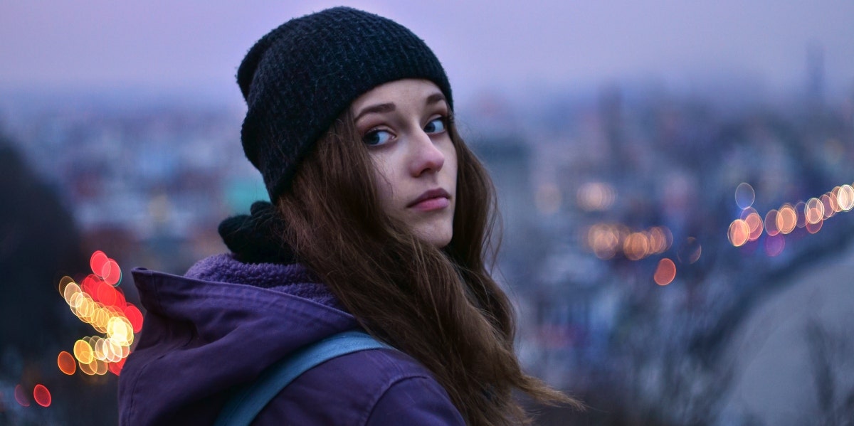 winter solstice woman with city lights behind her